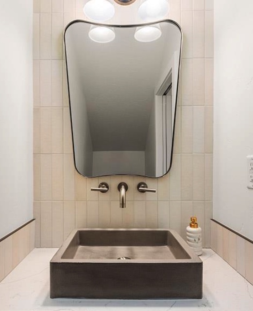 Powder room vanity with a tiled feature wall