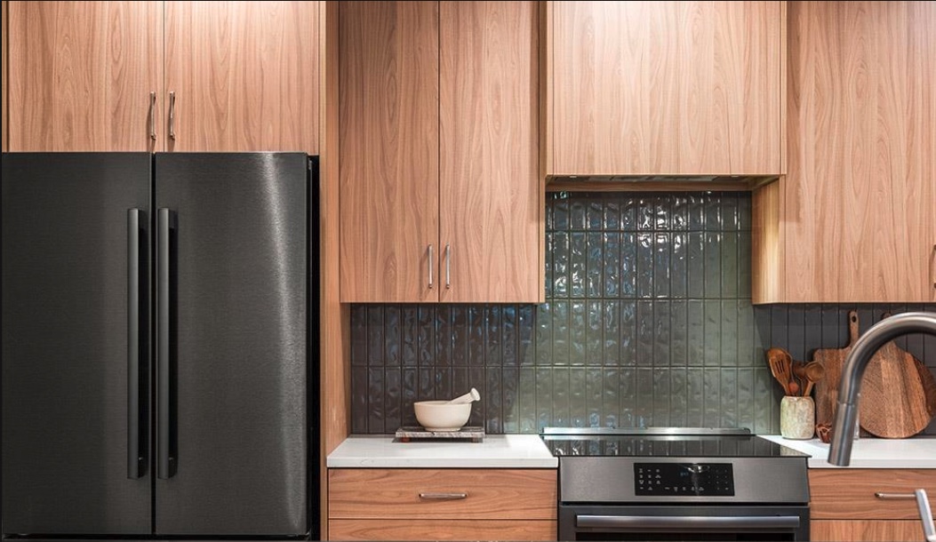 Kitchen with glossy dark tile backsplash