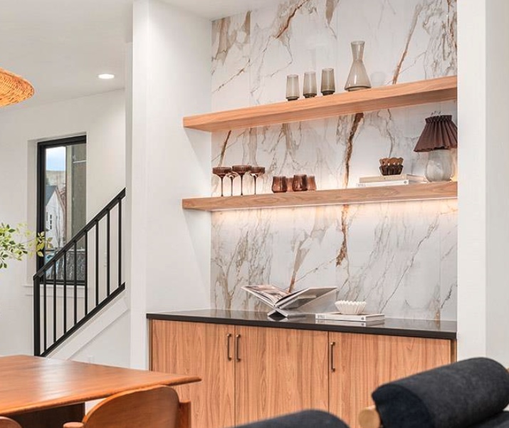 Large-format stone-look feature backsplash with wood shelving