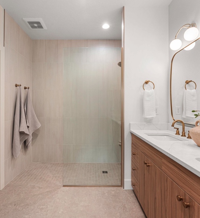 Bathroom with a tiled walk-in shower and tiled floor