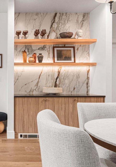 Large-format stone-look feature backsplash with floating wood shelves