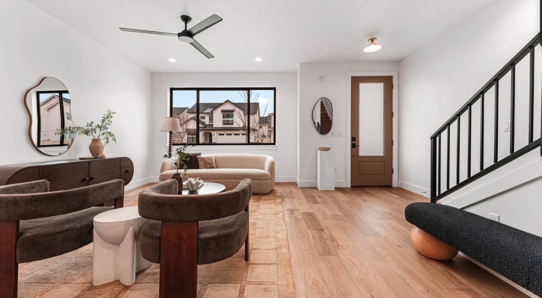 Entry and living room showing finished wood flooring