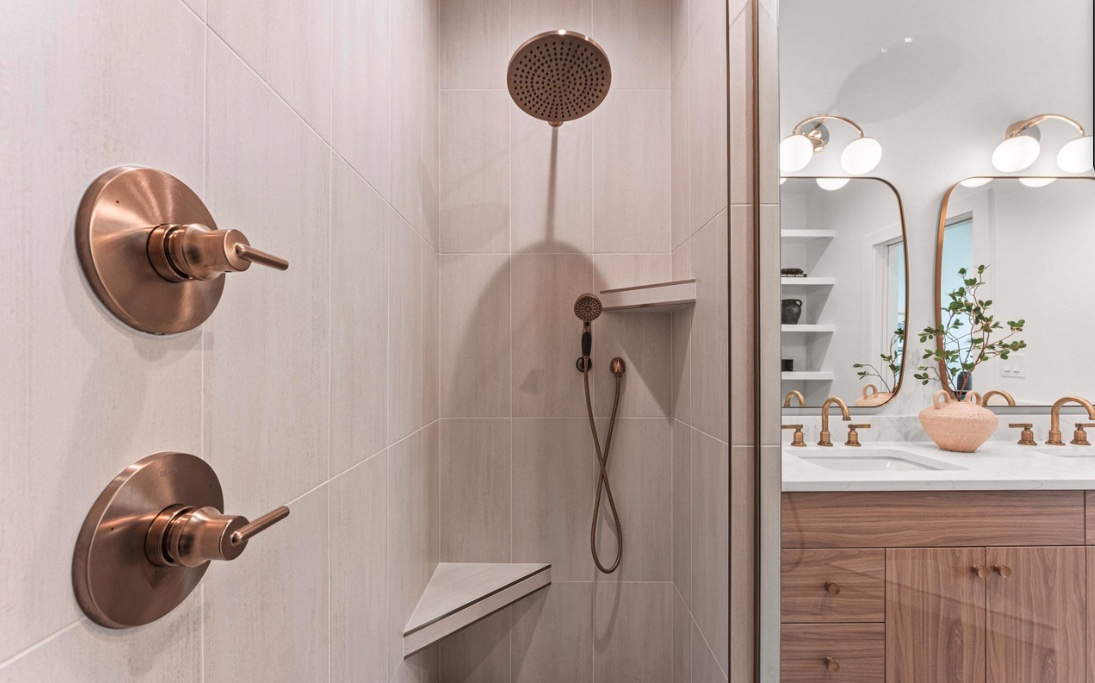 Walk-in shower with large-format tile and bronze fixtures